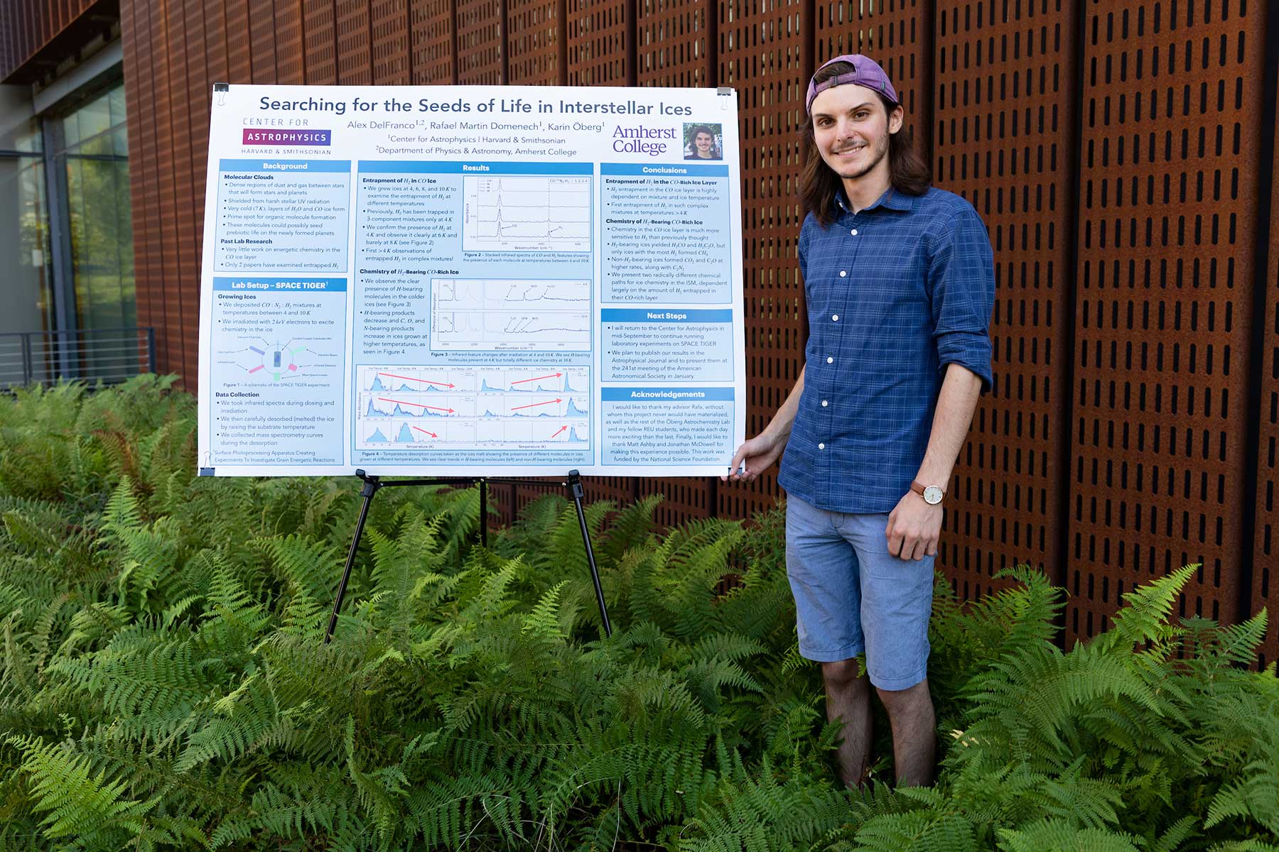 Alex DelFranco '24 holds a poster of his summer research on Searching for the Seeds of Life in Interstellar Ices.