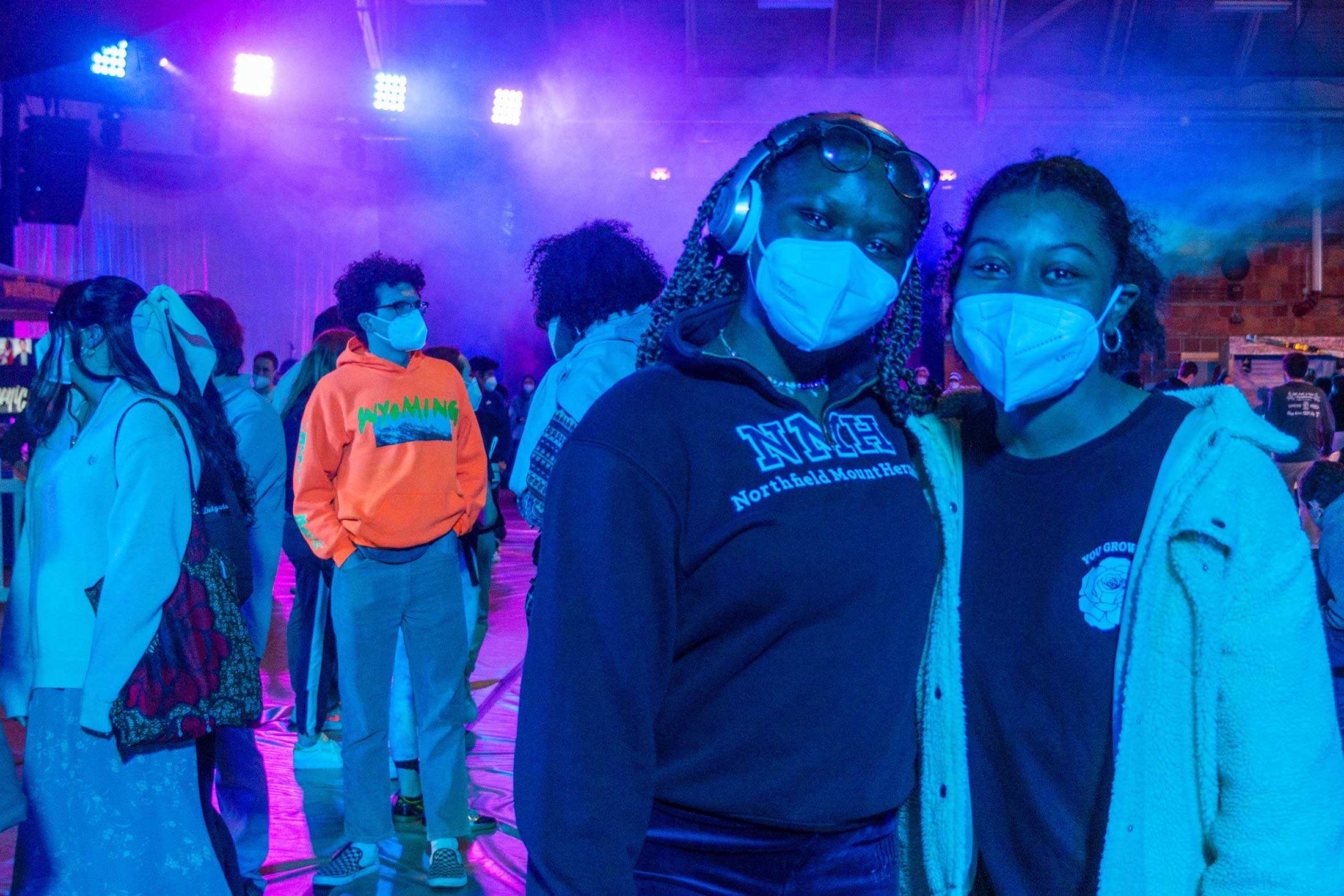 Two students, both wearing face masks, pose for a photo together during Winter Fest activities.