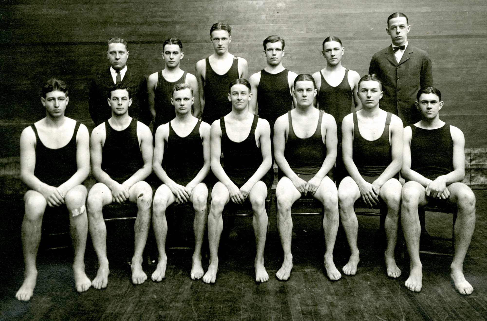 an 1800s men's swim team poses for a group shot