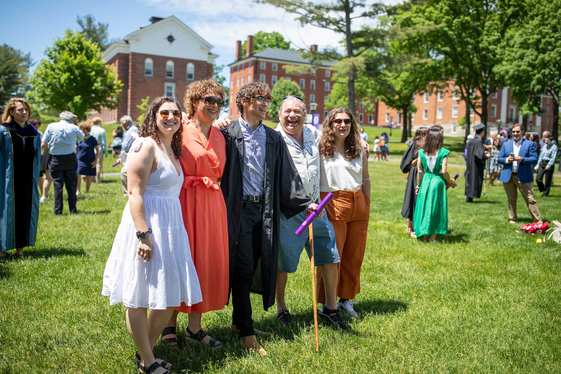 A family poses, celebrating graduation.