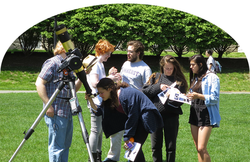 Students gathered outside around a telescope.
