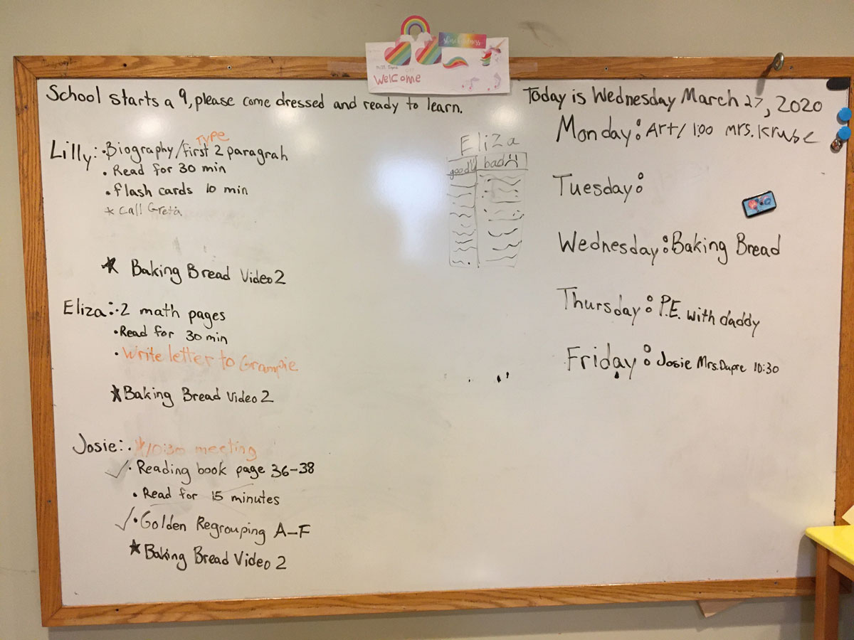 white board with a weekly schedule and kids homework