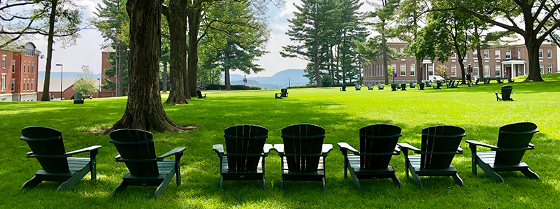 Chairs on the Amherst College Quad in the summer with Mount Holyoke in the distance