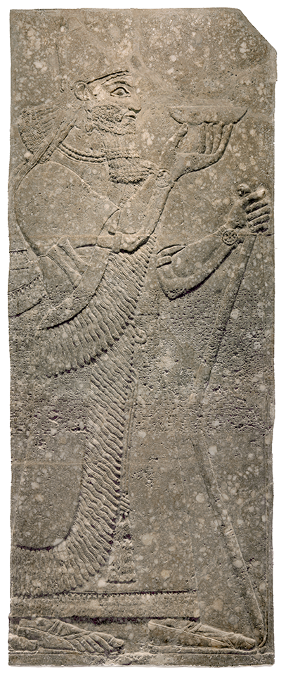 A large, carved stone panel depicting King Ashurnasirpal II in profile, facing right. He holds a small bowl aloft in one hand.