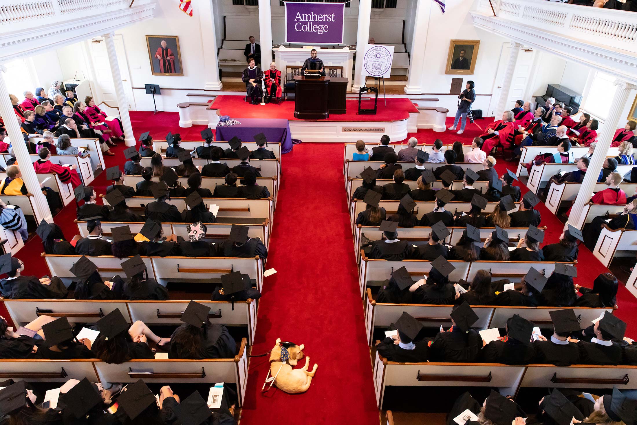 Student in commencement regalia gather in Johnson Chapel at Amherst College