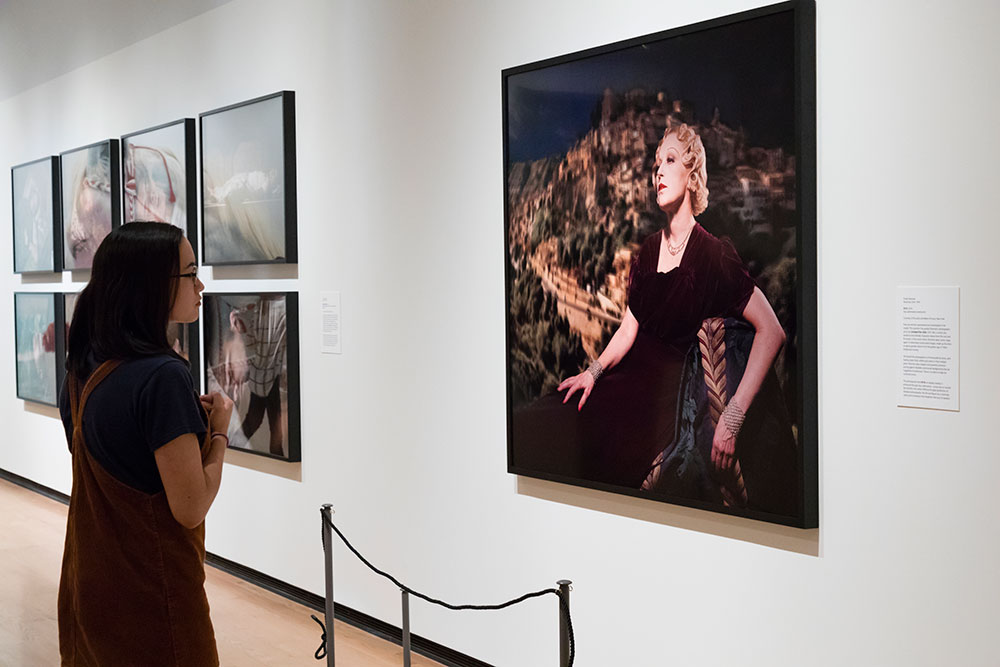 Visitor looking at artwork, a self-portrait by photographer Cindy Sherman