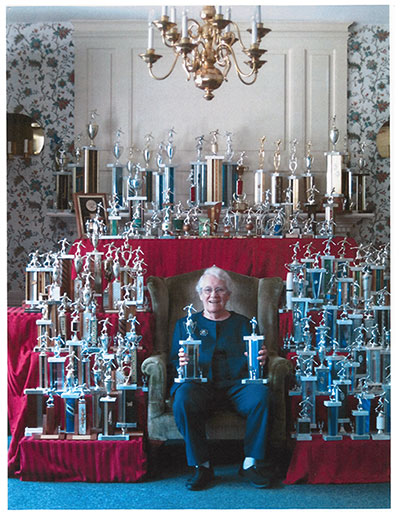 Barbara Tiffany surrounded by trophies