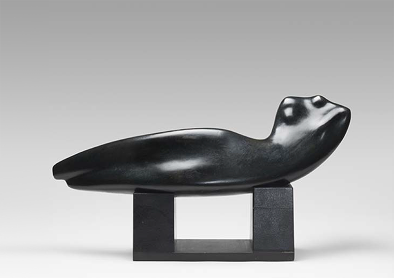 A modern sculpture of a woman lying down