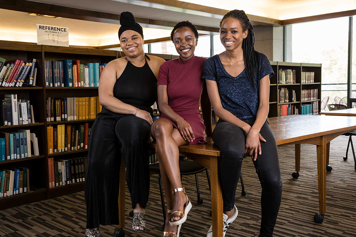 Three Black women sitting on a table in Frost cafe