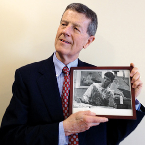 Bob Forrester’67 holding photo of of himself as art student.