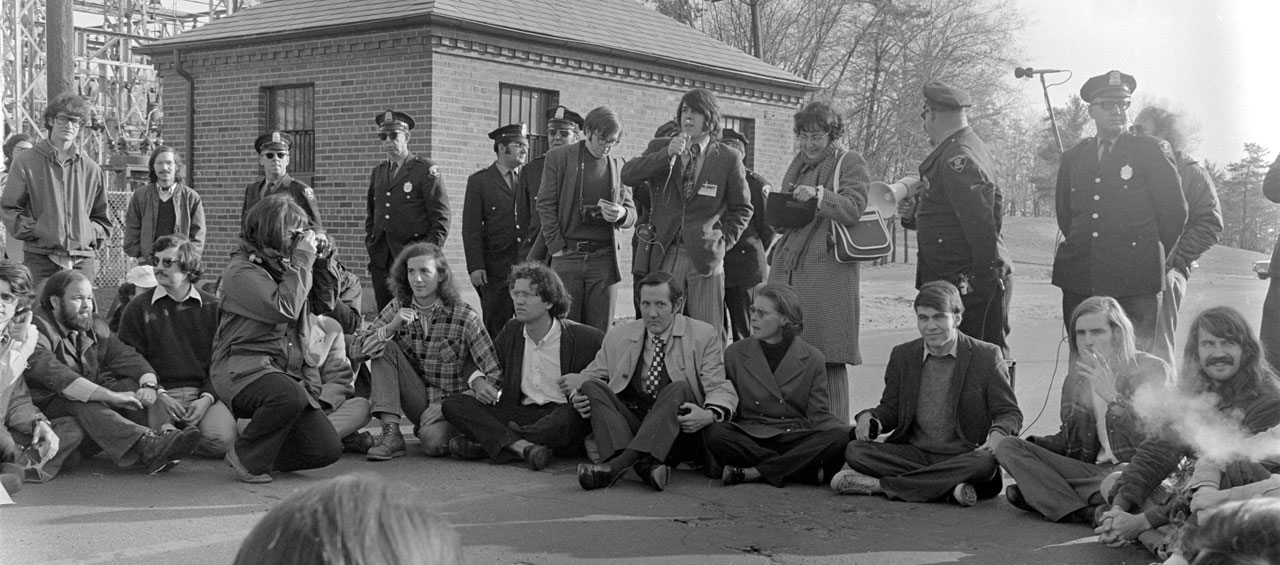 Amherst College President William Ward sits with students protesting the Vietnam War in 1972 at Westover Airforce Base
