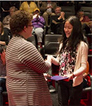 Biddy handing award to student