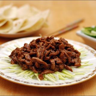 a meal featuring Jing Jiang Rou Si shredded pork in sweet bean sauce