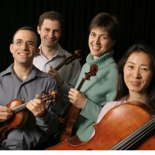 Brentano String Quartet holding their instruments