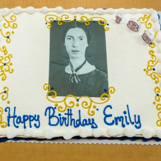 Cake decorated with a black-and-white portrait of Emily Dickinson and the words "Happy Birthday Emily"