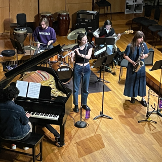 A five-person jazz combo playing various instruments in Room 7 of Arms Music Center