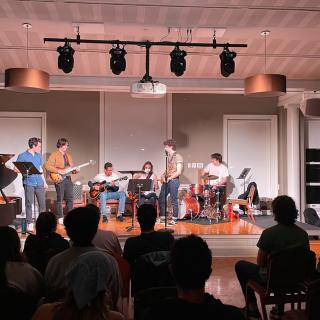 Jazz performers on stage in front of an audience in the Friedmann Room