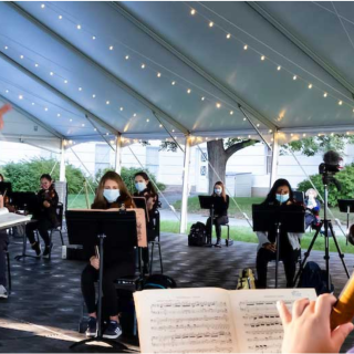 ASO rehearsing in an outdoor tent on campus, while wearing COVID masks