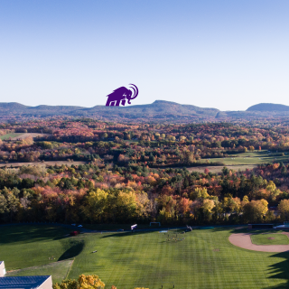 Western Massachestts landscape with foliage, mountains and a purple Mammoth logo in the distance