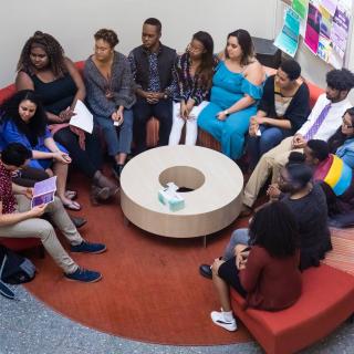 People sitting in a restorative circle in Keefe Campus Center Atrium