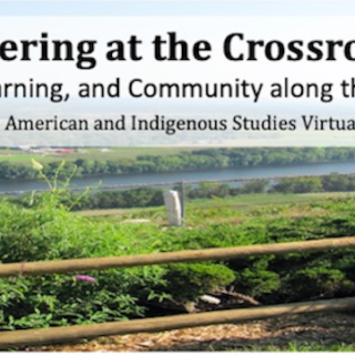 Symposium title and subtitle over the photo of a green landscape and a river running through it.