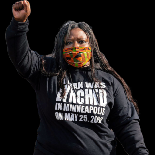 Nekima Levy Armstrong at a protest with arm raised