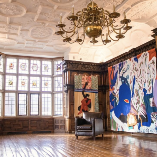 Installation photo of Rotherwas Project 5: Christopher Myers, The Red Plague Rid You for Learning Me Your Language. Quilts of many different fabrics and colors depicts scenes of Shakespeare's "The Tempest" and adorn the wood-paneled rooms of the Rotherwas Room.