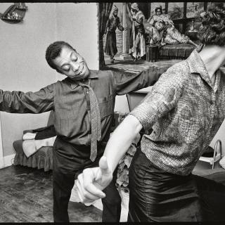 Black and White photograph of James Baldwin dancing, by photographer Steve Schapiro