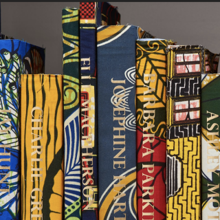 A row of books covered in brightly patterned fabric