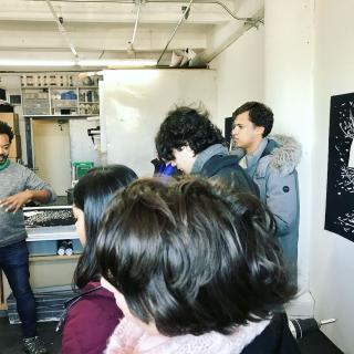 Students visiting the studio of artist William Villalongo