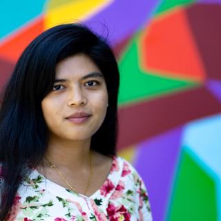 Thirii Myint with colorful abstract in background