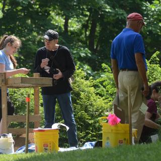 Four people engaged in an archaeological dig at the Emily Dickinson Museum