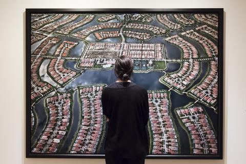 Woman looking at a large photo of a housing development