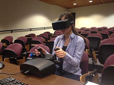 Person with virtual reality headset and mock airplane controls