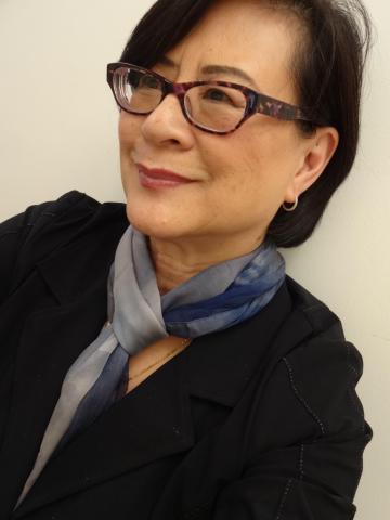 A photo of a woman in glasses smiling