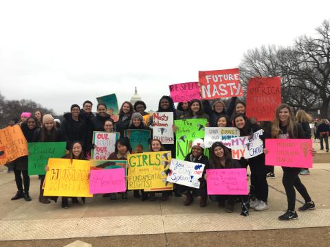 Women's March participants posed with posters