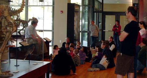 Young visitors at the museum listen to a presentation about skeletons