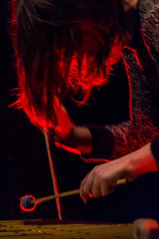 Portrait of percussionist Sarah Hennies playing xylophone