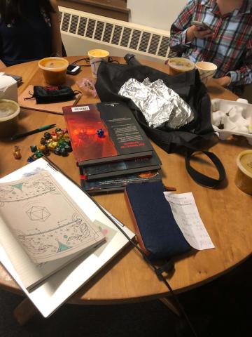 A table strewn with Indian food and D&D supplies