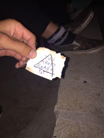 A burned note saying "You aren't ready"