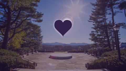 A heart pictured with the sun over memorial hill