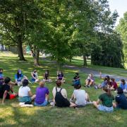 students sitting in a circle on the grass during Orientation