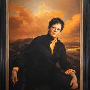 A presidential portrait of Biddy Martin against a dramatic background