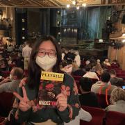 In front of the Hadestown stage holding a playbill
