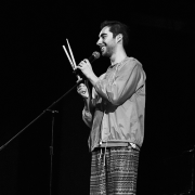 A black and white photo of a man holding drumsticks