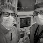 Two doctors in masks in an operating room