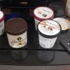 Tubs of ice cream on a frig