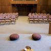 A stage in a chapel with two cushions and a bowl